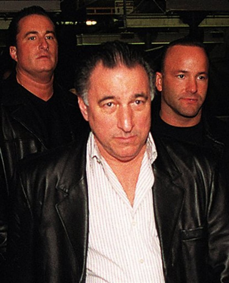 In this 2001 photo, reputed boss of the Philadelphia mob Joseph "Uncle Joe" Ligambi, center, along with two unidentified men exit federal court in Philadelphia. A federal judge ordered Ligambi held without bail on Thursday, May 26, 2011 on racketeering and gambling charges.